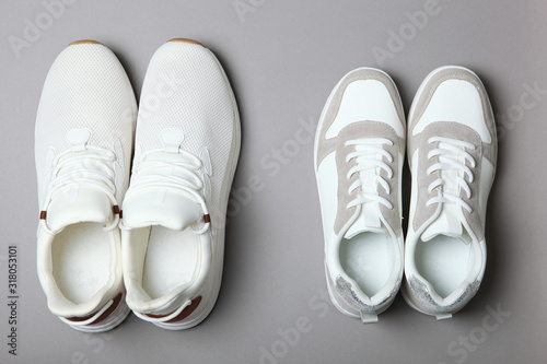 Men's and women's sneakers on a colored background top view. Sport shoes. White running shoes