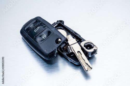 Close-up dirty broken or damaged car key fob on aluminium background locksmith service.- Image