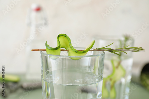 Glass of cold cucumber water, closeup