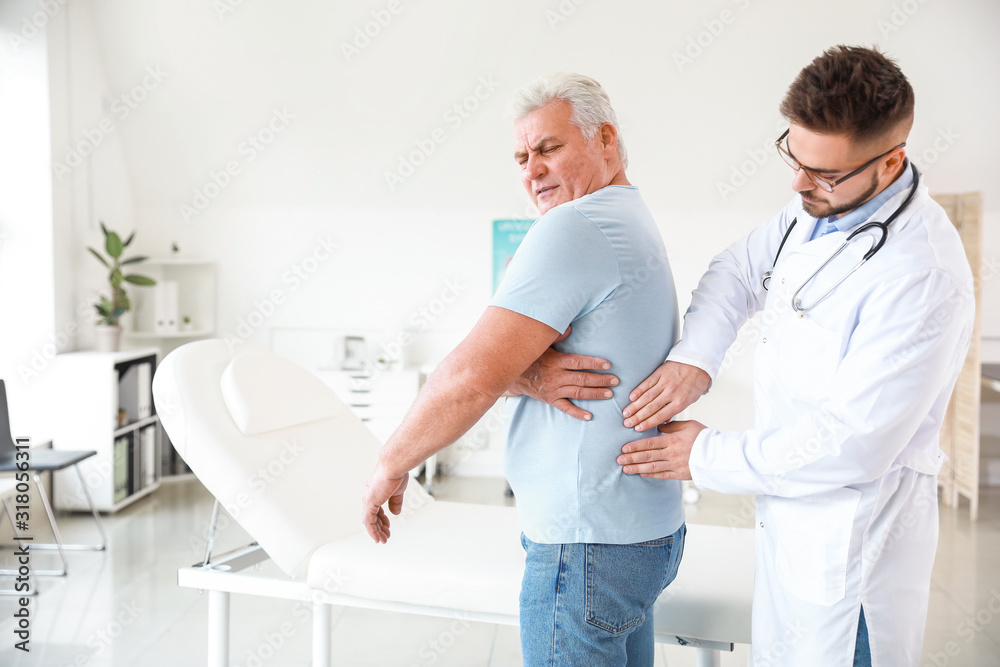 Fototapeta premium Urologist examining mature patient in clinic
