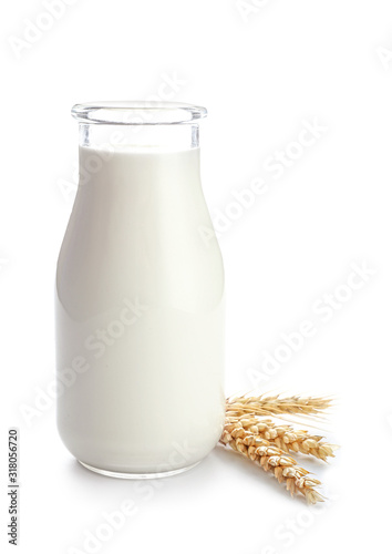 Bottle of tasty milk on white background