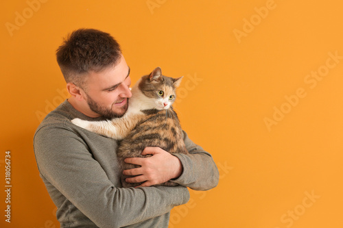 Man with cute cat on color ...