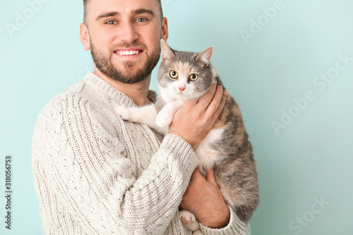 Man with cute cat on color ...