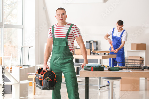 Portrait of furniture assembler in workshop