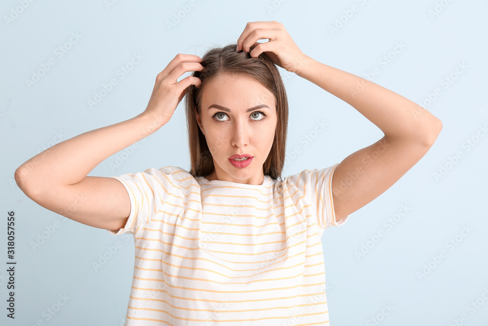 Young woman with hair loss problem on color background Young woman with hair loss problem on color background