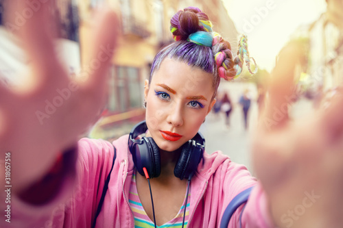 Fotótapéta Playful cool rebel funky hipster young girl with headphones and crazy hair takin