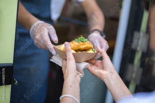 Street Food  Fried Fish and Chips Served in a Small Paperboard