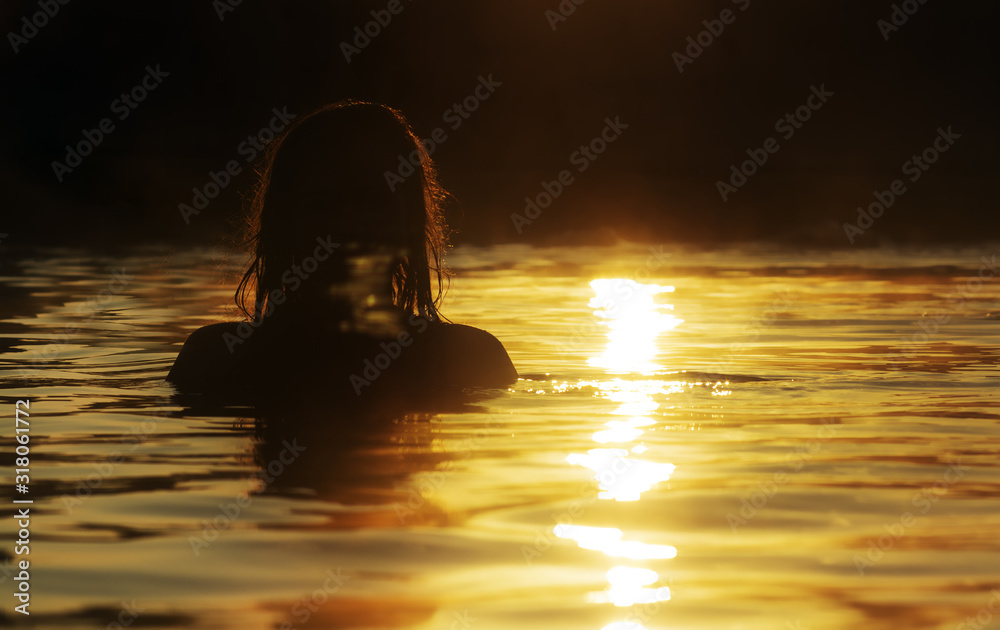 silhouette of a beautiful girl with wet hair in water, head of a woman