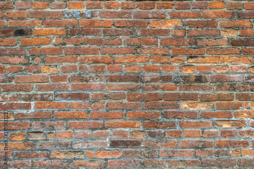 Weathered old red brick background with rough surface.