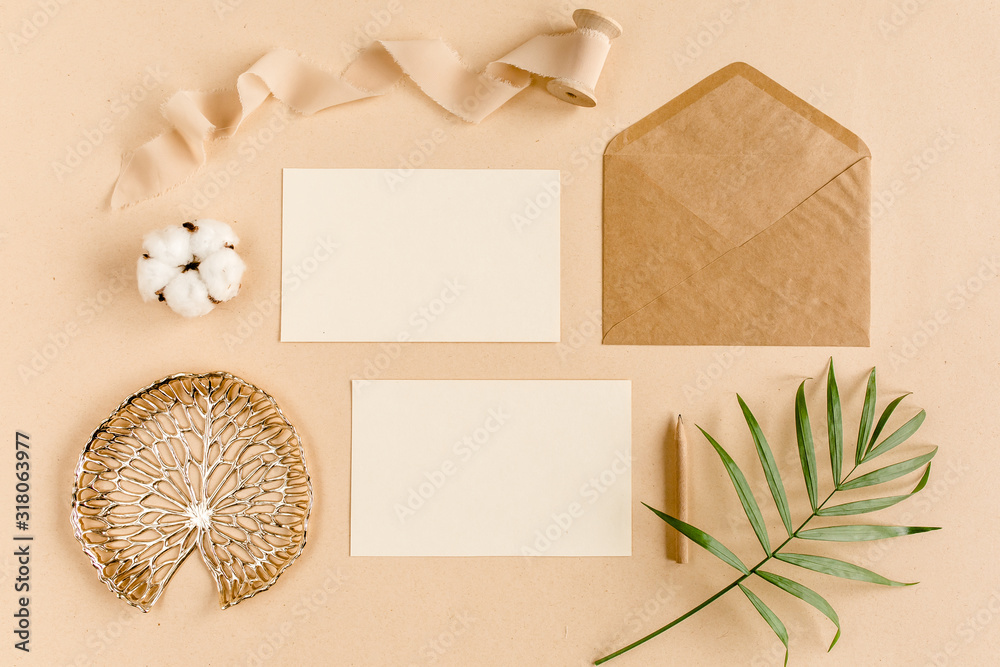 Mockup wedding invitation, blank greeting card and craft envelope, tropical palm leaves. Flat lay, top view. Mockup wedding invitation, blank greeting card and craft envelope, tropical palm leaves. Flat lay, top view.
