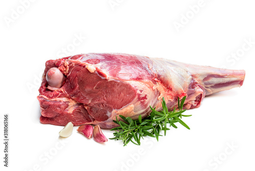 Photos Fresh raw lamb leg with rosemary leaves and garlic isolated on white
