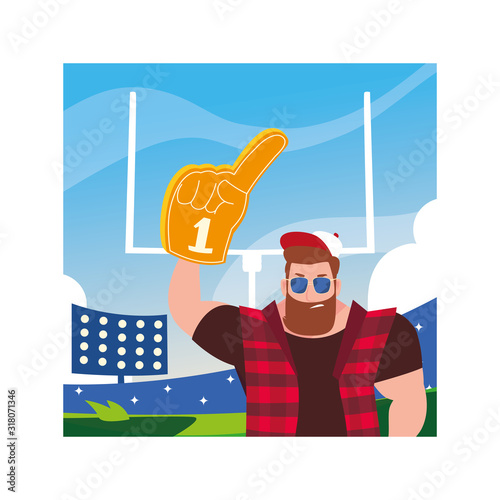 man holding a hand glove with number 1 fan, yellow foam finger in stadium