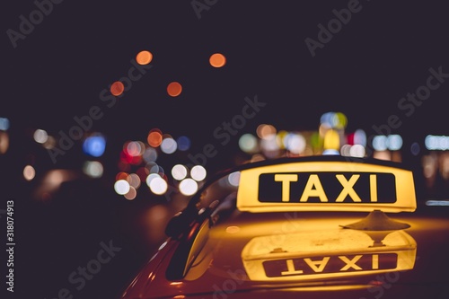 Leinwand Poster Closeup of a taxi sign on a cab during night time