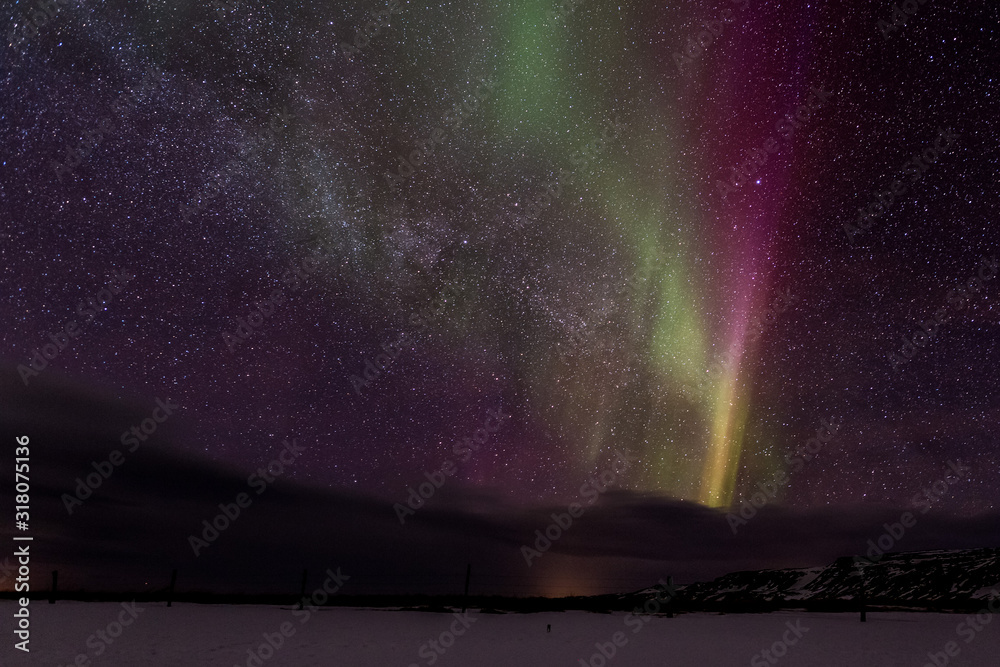 Northern lights ( Aurora Borealis ) over the Milky Way in Iceland