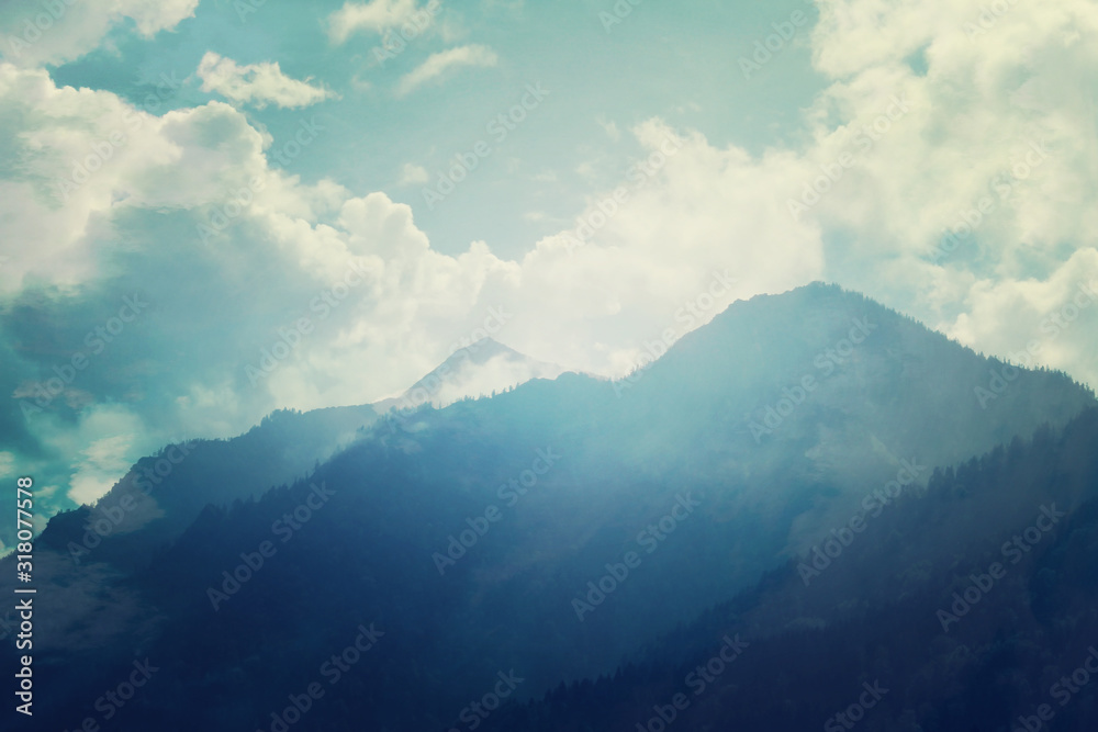 Mountains, sun and blue sky on summer day. Beautiful mountain background	