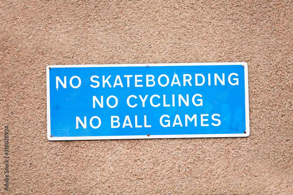 No skateboarding cycling or ball games sign on private property wall No skateboarding cycling or ball games sign on private property wall