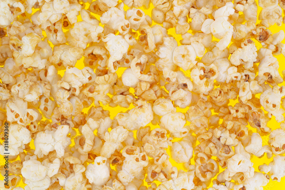 Sweet popcorn on a yellow background close-up top view Sweet popcorn on a yellow background close-up top view