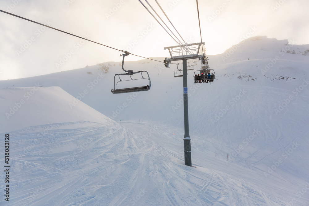 Whistler Ski Resort, British Columbia, Canada. Beautiful View of the snowy Canadian Nature Landscape Mountain and Chairlift going to the peak during a vibrant winter morning.