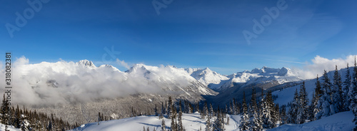 Whistler, British Columbia, Canada. Beautiful View of the Canadian Snow Covered Landscape with Blackcomb Mountain in Background during a cloudy and sunny winter day.