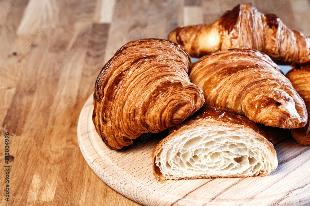 Many fresh croissants on wooden board. Many fresh croissants on wooden board.