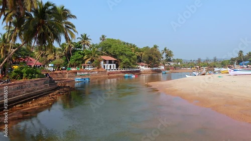 Aerial view of a small Indian river with wooden fishing boats on Baga Beach, Goa, India
