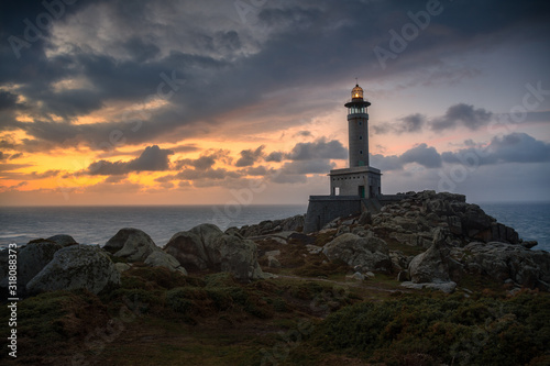 Punta Nariga lighthouse during a beautiful sunset with a dramatic sky. Malpica de Bergantiños, Galicia, Spain.