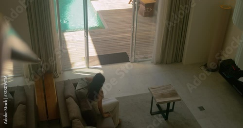 Beautiful girl in white dress live in modern design villa. Sensual woman enjoying beverage in luxury apartment. Rich people enjoying summer leisure. Business woman on vacation away from work.