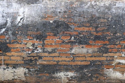 punky wall background - black painted surface with orange bricks  photo