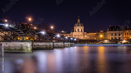 Paris pont des Arts leading towards Institut de France, by night long exposure