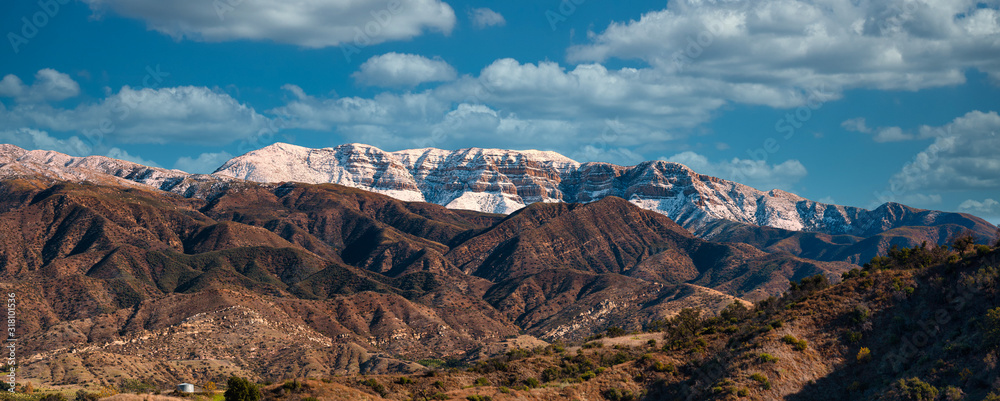 Snow covered Topa bluffs over Ojai Valley farms and vineyards