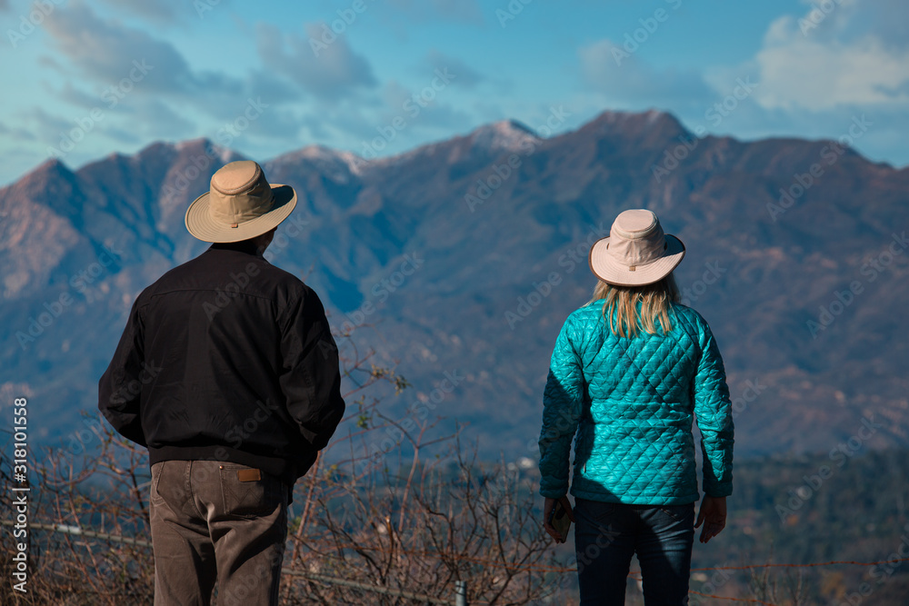 Couple looks out over the Ojai Valley after a light snow