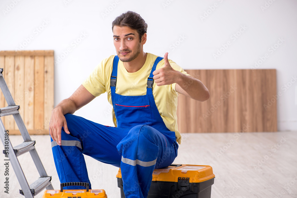 Young male contractor working indoors Young male contractor working indoors