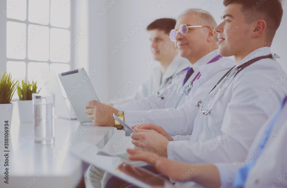 Medical team sitting and discussing at table Medical team sitting and discussing at table