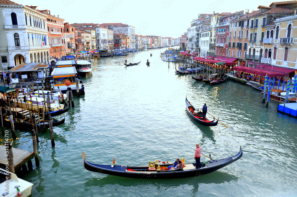 The view of boats and building by Rialto Bridge in Venice, Italy