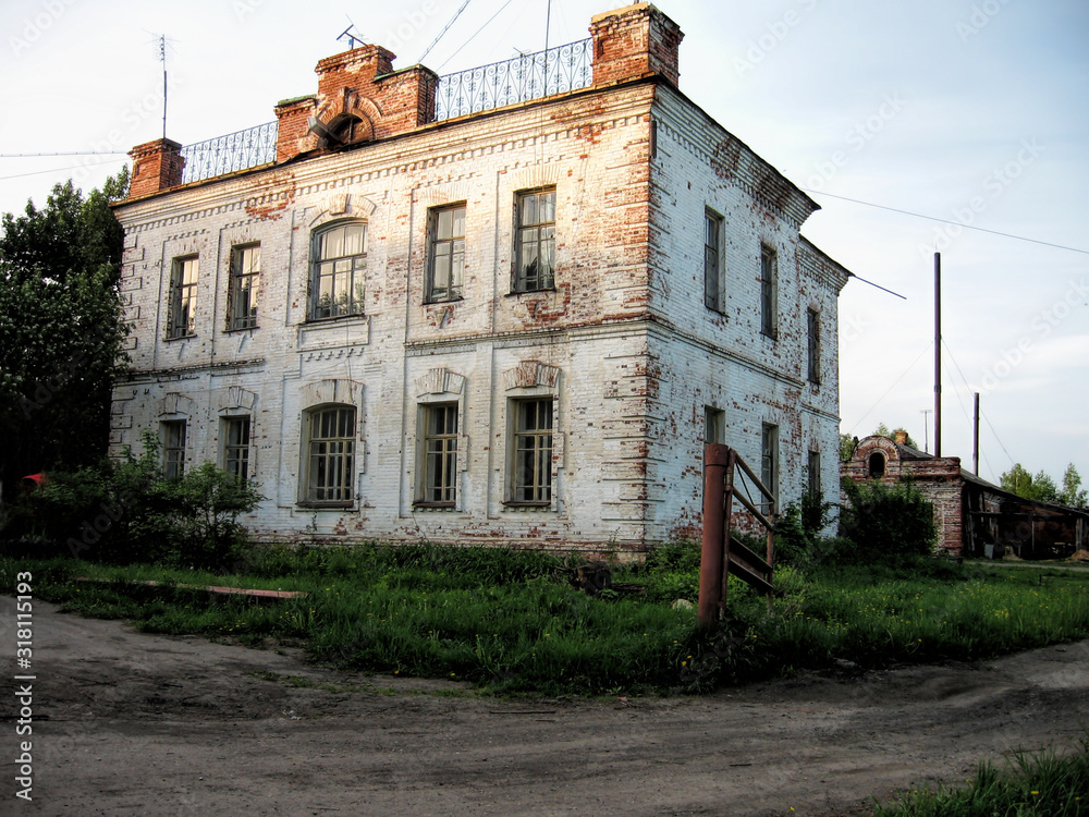 Old two-story stone building in summer in Russia