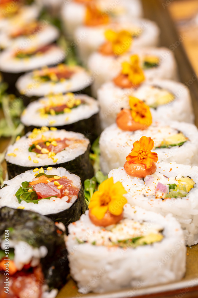 Inside and outside Sushi Rolls decorated with flowers and trimmings Inside and outside Sushi Rolls decorated with flowers and trimmings