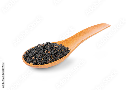 Fotografía Black sesame seeds in wooden spoon isolated on white background.