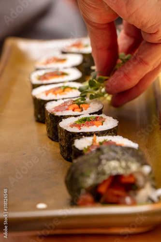 Sushi roll being sliced in a demonstaration class