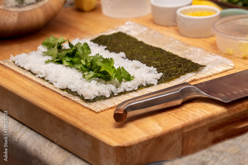 Chef preparing ingredients and teaching how to make Sushi