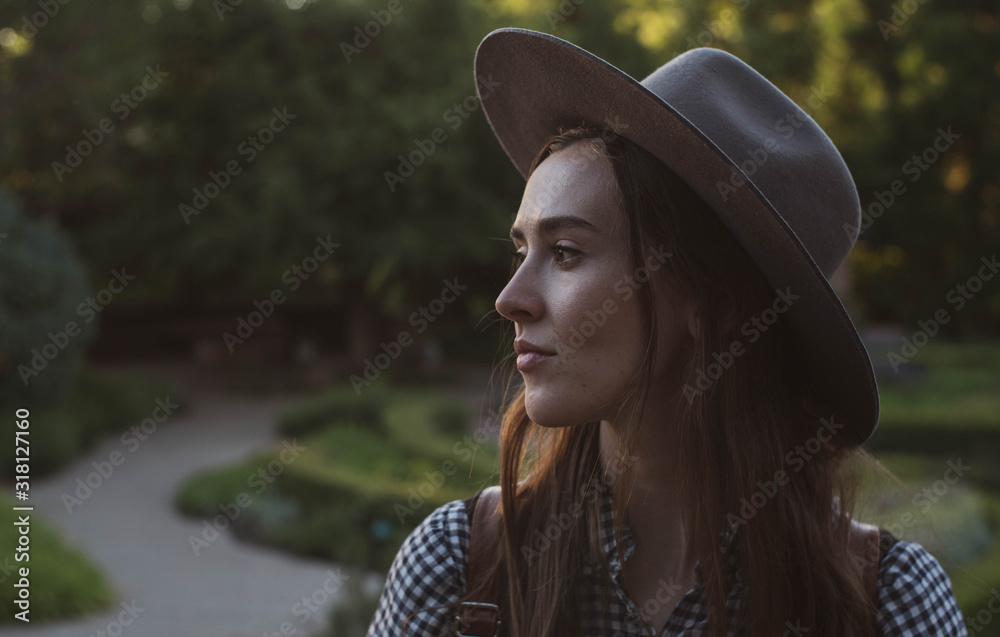 young beautiful female smiling in garden at sunset