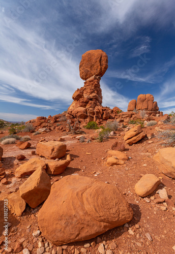 red rock sandstone feature in desert with blue sky