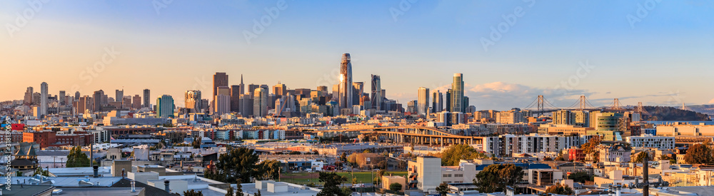 San Francisco city skyline panorama after sunset with city lights, the Bay Bridge and highway leading into the city