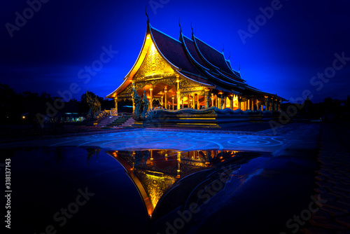 Amazing Temple Sirindhorn Wararam Phuproud in Ubon Ratchathani Province at twilight time,Thailand.Thai temple with grain and select white balance.Night sky effect for Long exposure fluorescent light. © noon@photo