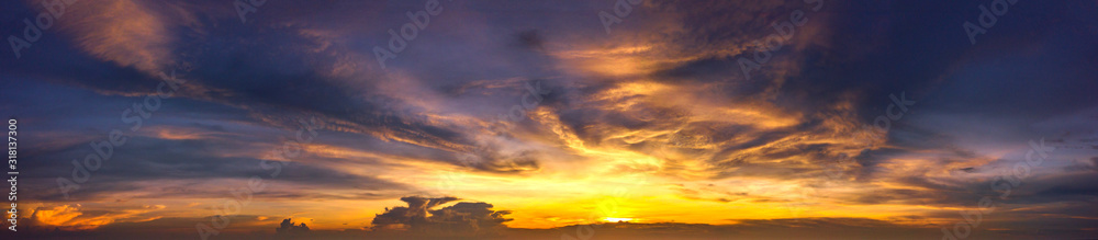 Panorama Sunset with clouds, in orange and colorful shades,World Environment Day concept: Fiery orange sunset sky with dark clouds.