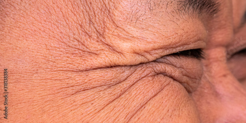 Brown skin and facial wrinkles, eyebrows, eyelashes of Asian middle-aged men.