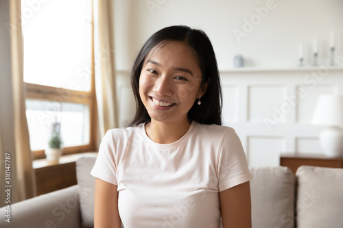 Headshot of millennial Asian woman have video call