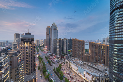 Bird view at Nanchang China. Skyscraper under construction in foreground. Fog, overcast sky and pollution. Bund (Nanchang) area