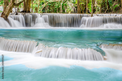 Travel to the beautiful waterfall in tropical rain forest  soft water of the stream in the natural park at Kanchanaburi  Thailand.