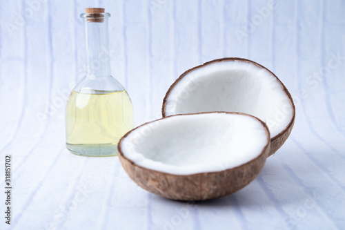  coconuts and Coconut oil  in a bottle  for cooking   nutrition  vegan ingredient  natural put on a white table,  Concept: alternative aromatherapy aromatic ingredient vitamin for therapy and massage 