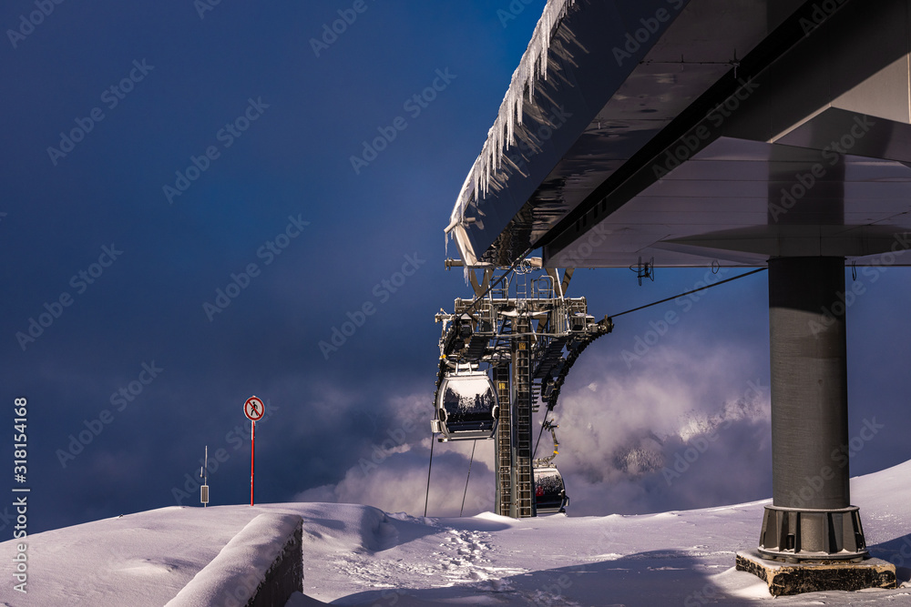Mountain resort Rosa Khutor in Sochi. The top of the mountain is Rosa Peak 2320 meters. Ski resort. Winter sunny day in the Caucasus mountains. Mountain resort Rosa Khutor in Sochi. The top of the mountain is Rosa Peak 2320 meters. Ski resort. Winter sunny day in the Caucasus mountains.
